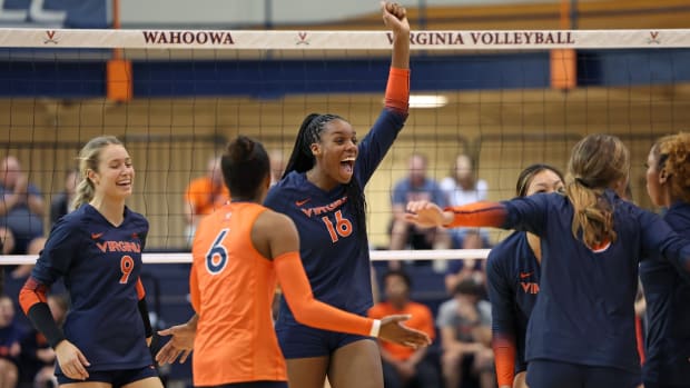 The Virginia volleyball team celebrates after scoring a point during the match against Wofford at Memorial Gymnasium in Charlottesville.